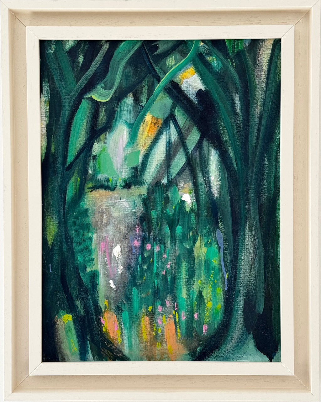 Framed painting of a forest scene with green and brown tones.